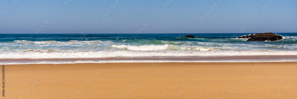 Sandy beach with Rock formation, Atlantic ocean coastline of Portugal.