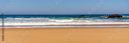 Sandy beach with Rock formation, Atlantic ocean coastline of Portugal.