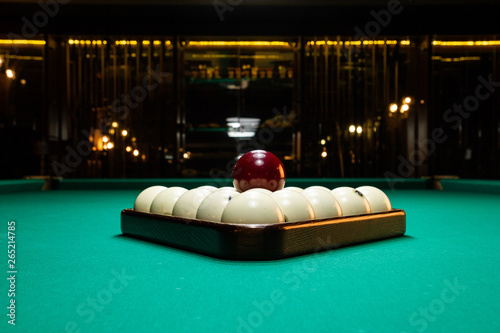 Fotografie Close-up billiard balls ivory folded triangle on a table covered with green baiz