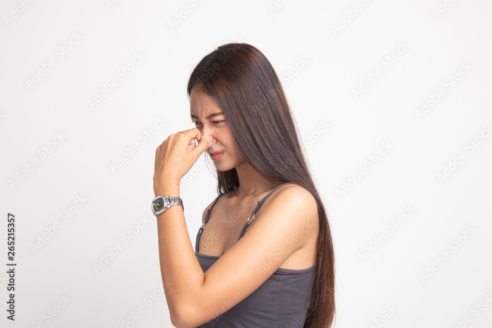 Young Asian woman holding her nose because of a bad smell. Young Asian woman holding her nose because of a bad smell.