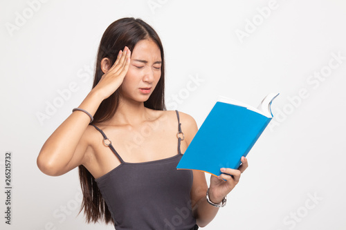 Young Asian woman got headache read a book.