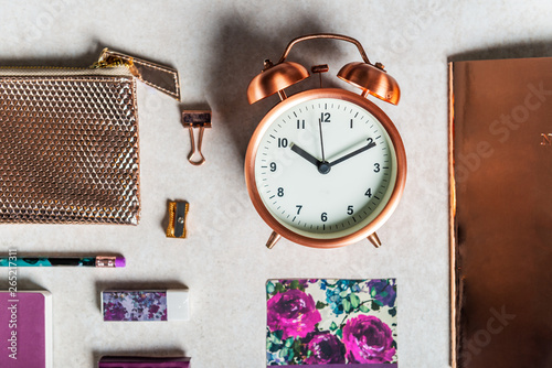 Notebooks for writing Dreams and Ideas, with different gold and maroon Stationery laying on grey background. Top View. Idea of Girly Office settings. Flat lay style photo