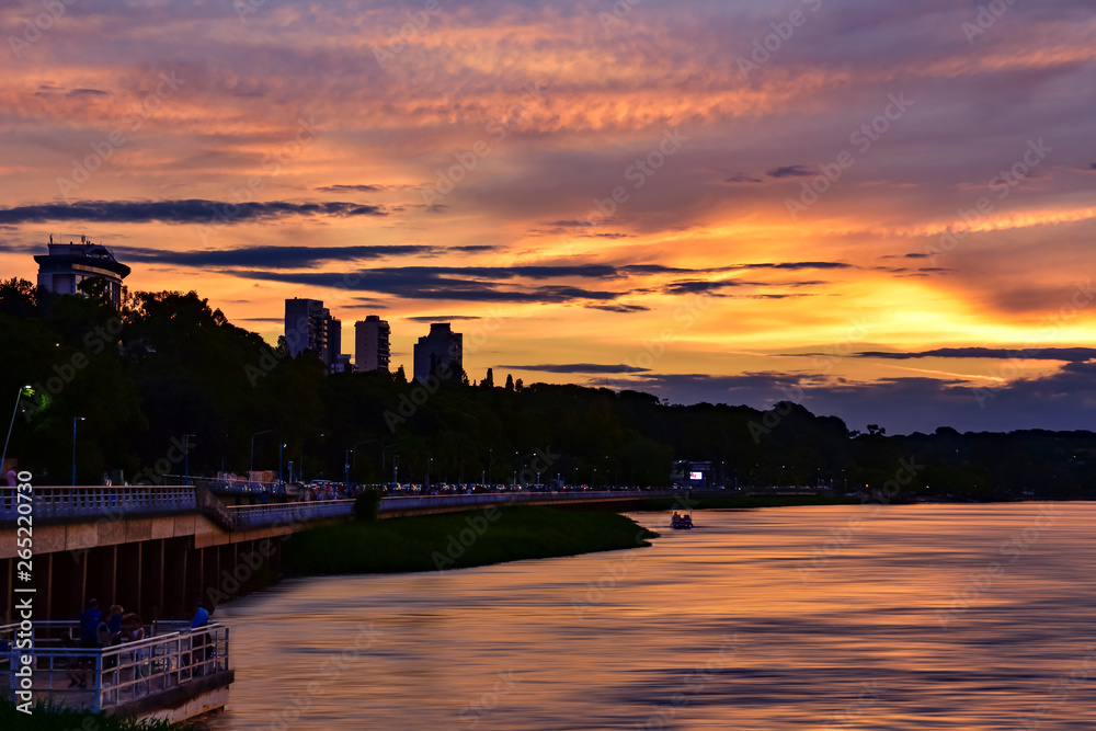 Fototapeta premium View of a golden sunset sky with clouds from the river shore