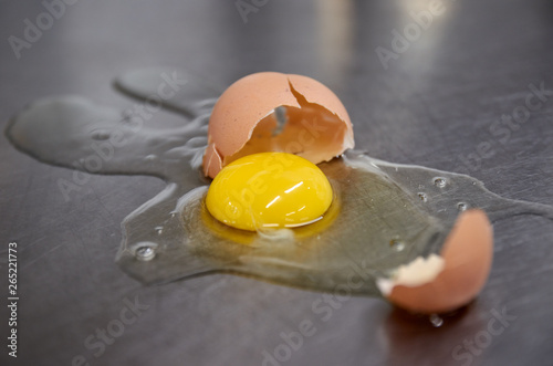 Broken chicken egg on the iron table close-up. horizontal view. a raw egg.
