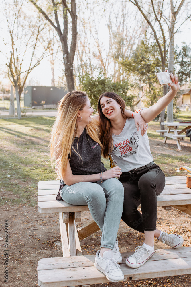 Smiling women taking selfie in park Smiling women taking selfie in park