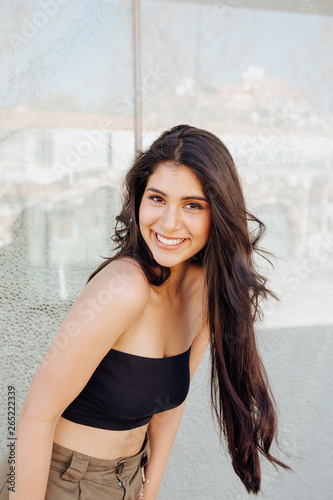 Beautiful female standing near wall photo