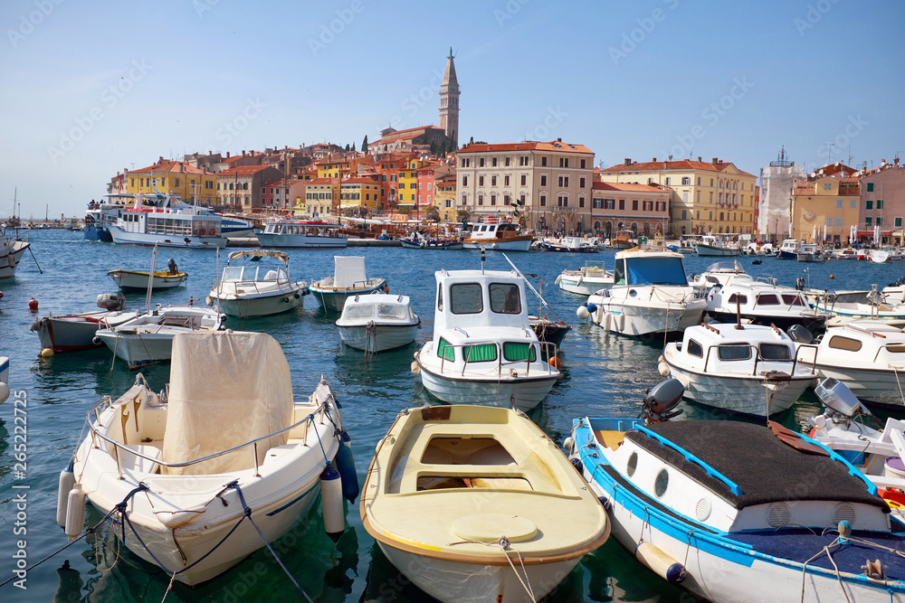 Rovinj (known also Rovigno) harbor with lots of boats in the foreground and the St. Euphemia church’s tower in the background in Istrial, Croatia.