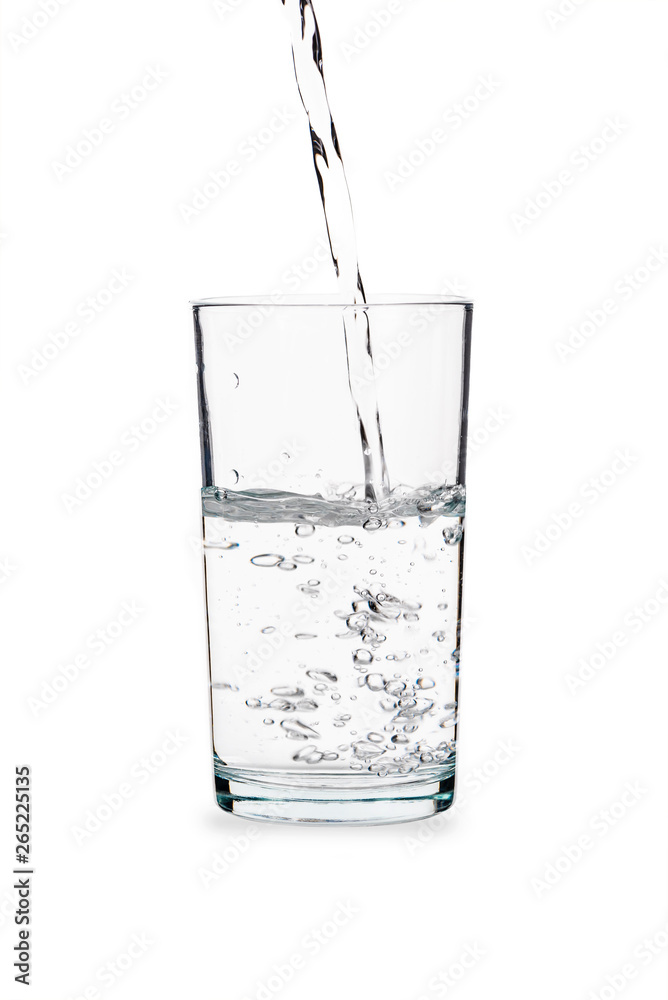 Pouring water into glass isolated on white Pouring water into glass isolated on white