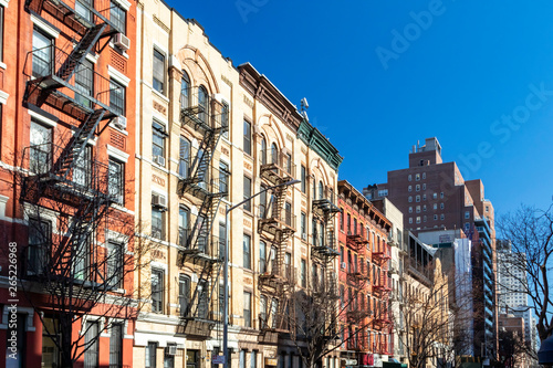 Block of colorful old buildings with clear blue sky background in the Upper East Side of Manhattan in New York City © deberarr