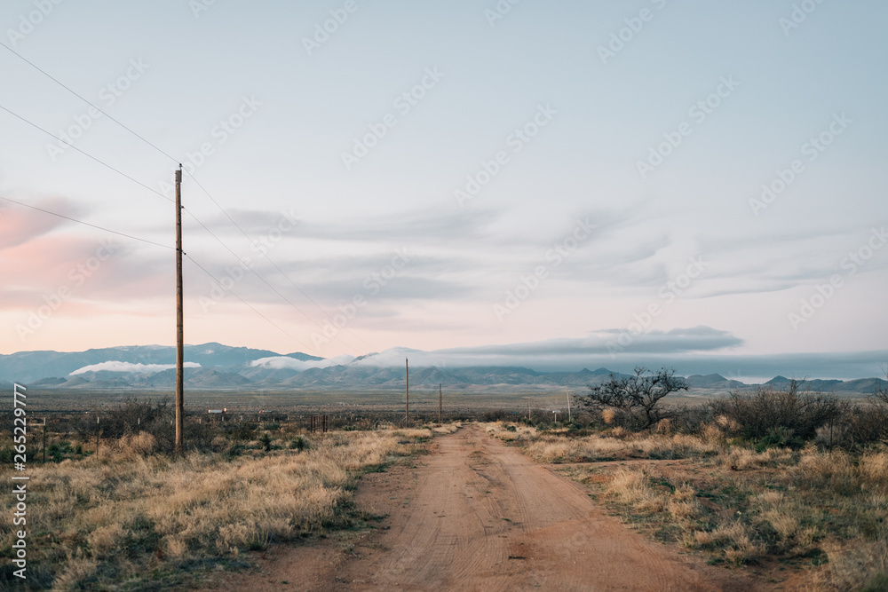 Dirt road and mountains at sunset in the desert of eastern Arizona