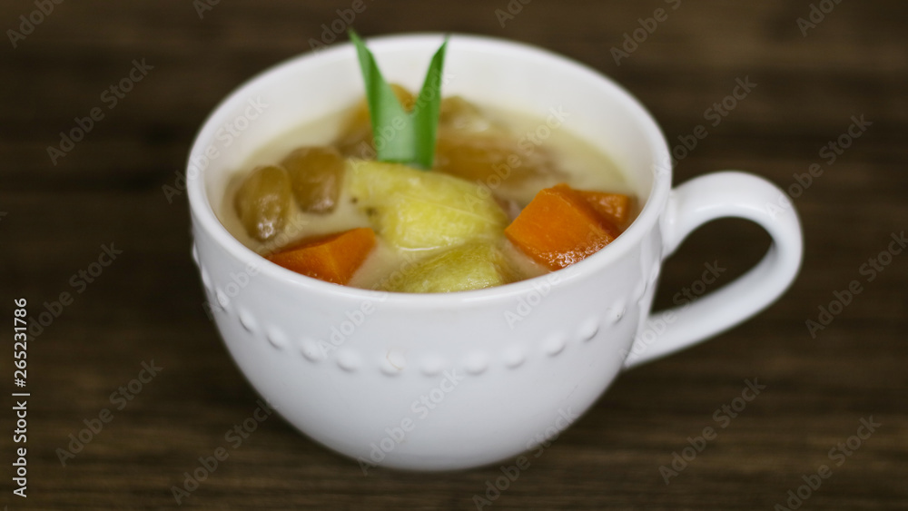 Indonesian sweet desserts or kolak on wood background. Indonesian sweet desserts or kolak on wood background.