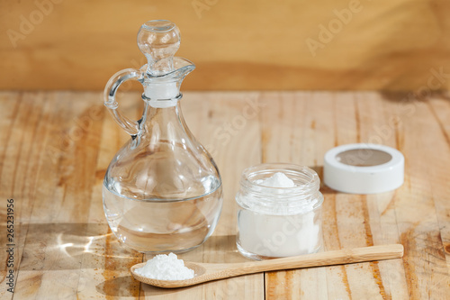 Photos baking soda - sodium bicarbonate and vinegar, on wooden background