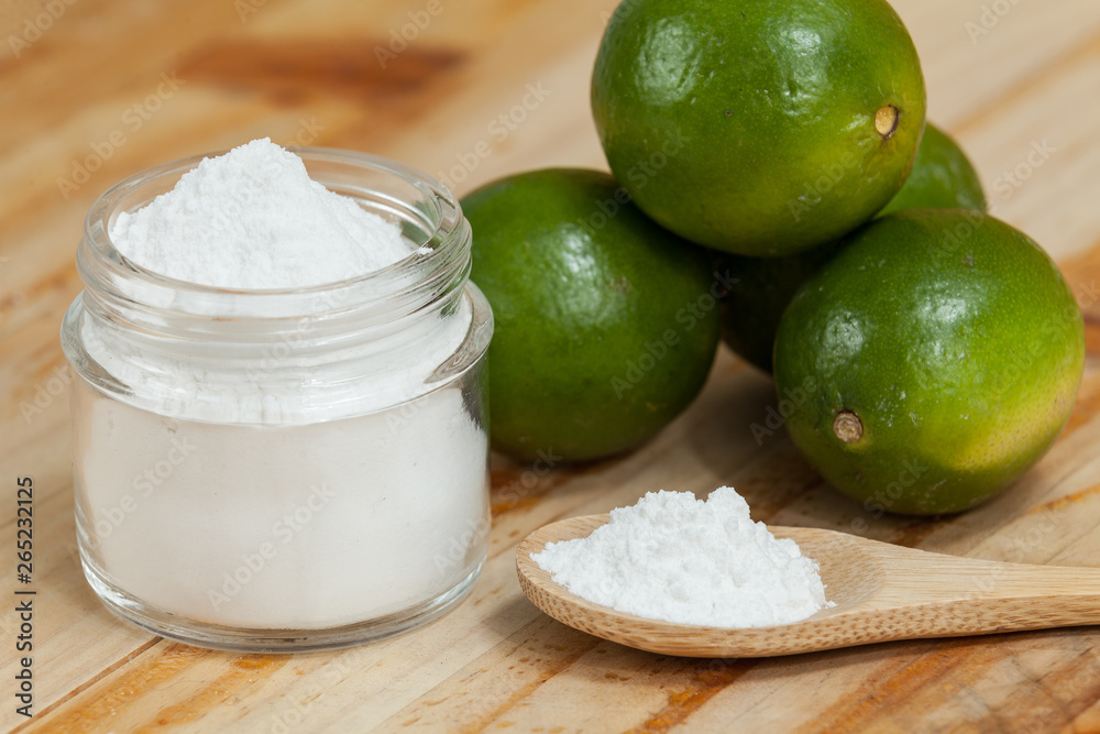 baking soda - sodium bicarbonate and lemon, on wooden background baking soda - sodium bicarbonate and lemon, on wooden background