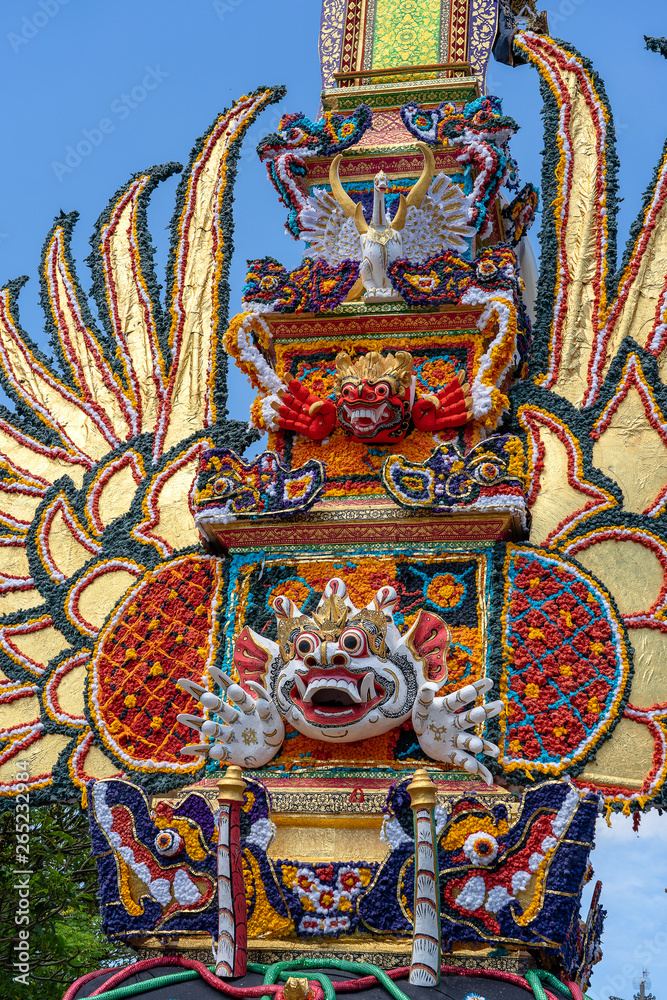 Fototapeta premium Bade cremation tower with traditional balinese sculptures of demons and flowers on central street in Ubud, Island Bali, Indonesia . Prepared for an upcoming cremation ceremony