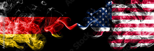 Germany vs United States of America, American smoky mystic flags placed side by side. Thick colored silky smoke flags of Deutschland and United States of America, American