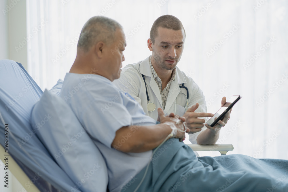 Obraz premium happy asian elderly looking at a good result of health check up in the medical chart with doctor.