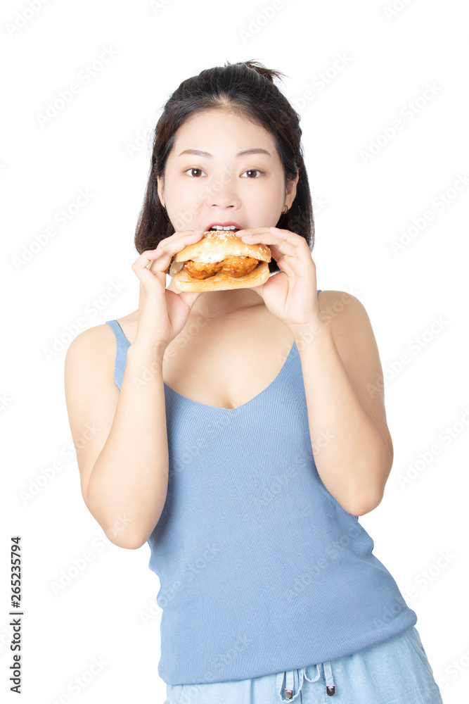 Chinese American woman eating Chicken Sandwich isolated on white background Chinese American woman eating Chicken Sandwich isolated on white background
