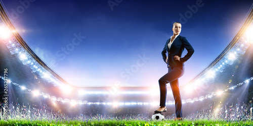Business lady on football stadium. Mixed media © Sergey Nivens