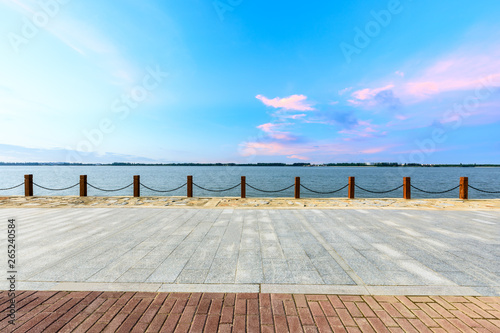 Fototapeta Naklejka Na Ścianę i Meble -  Beautiful lake and walkway with sky clouds at sunset