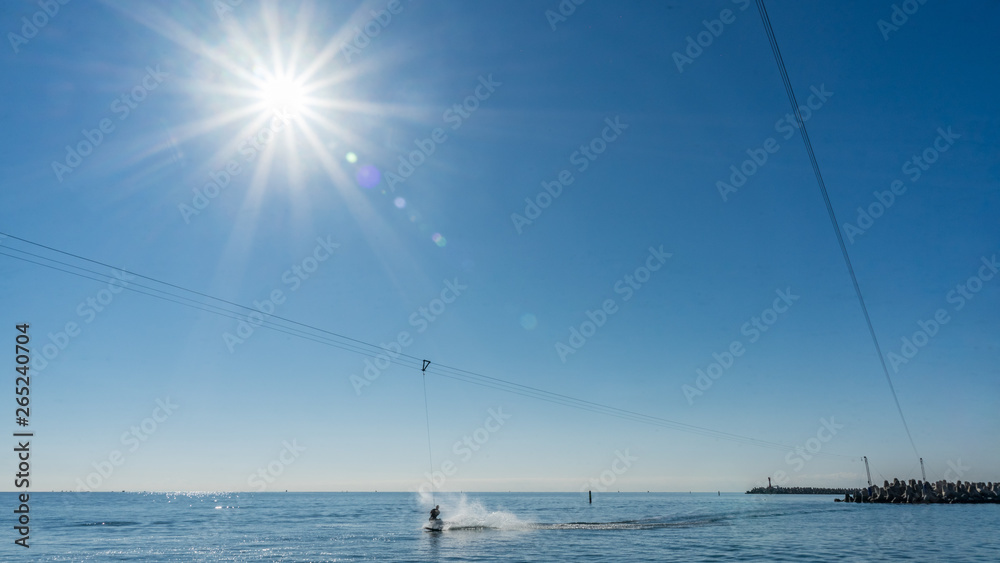 Wakeboardingnear seaport in Sochi. Sunshine on background. Russia.