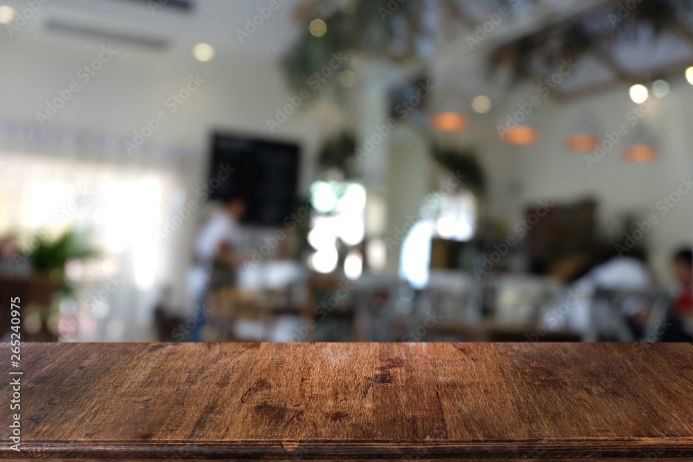 Empty dark wooden table in front of abstract blurred bokeh background of restaurant . can be used for display or montage your products.Mock up for space. Empty dark wooden table in front of abstract blurred bokeh background of restaurant . can be used for display or montage your products.Mock up for space.