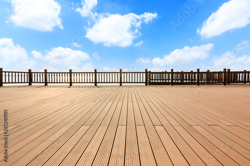 Lakeside wood floor platform and blue sky with white clouds