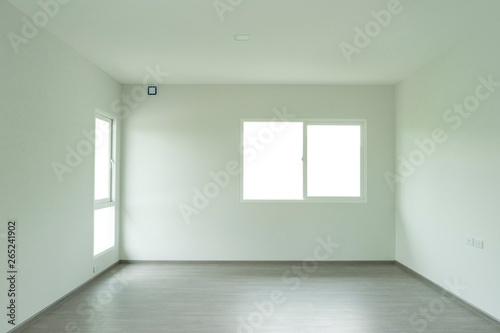 Empty room of a house with door and window.