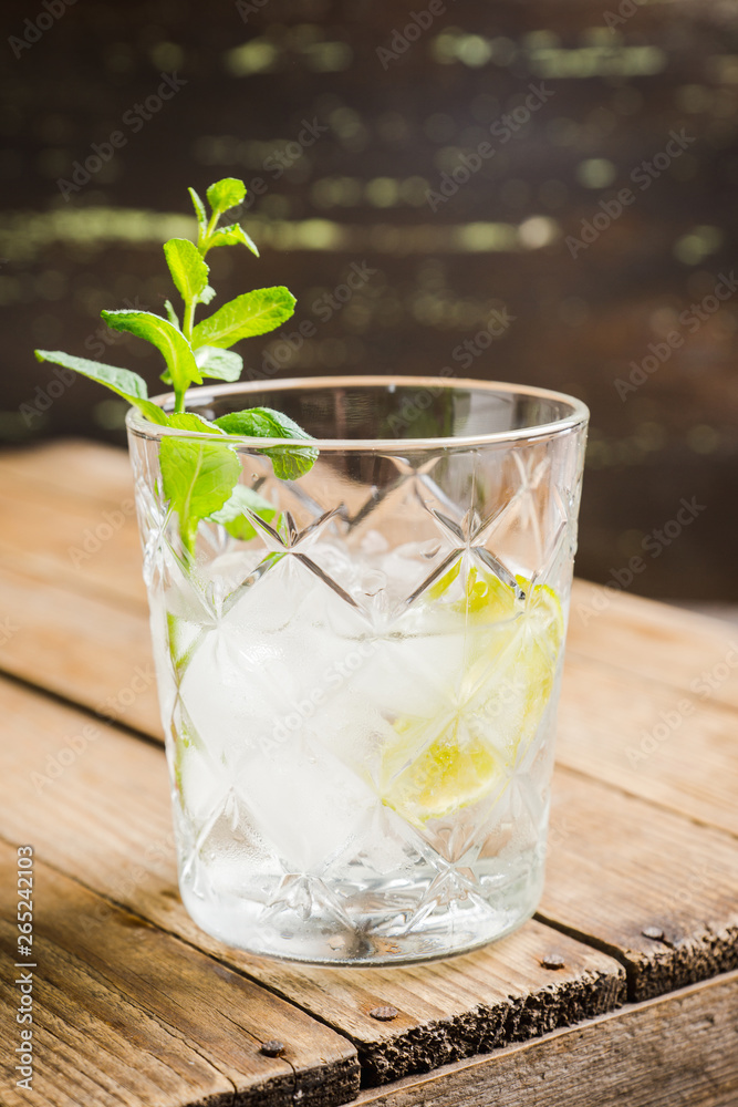 Old fashioned beverage with lime and mint leaves. Selective focus. Shallow depth of field. Old fashioned beverage with lime and mint leaves. Selective focus. Shallow depth of field.
