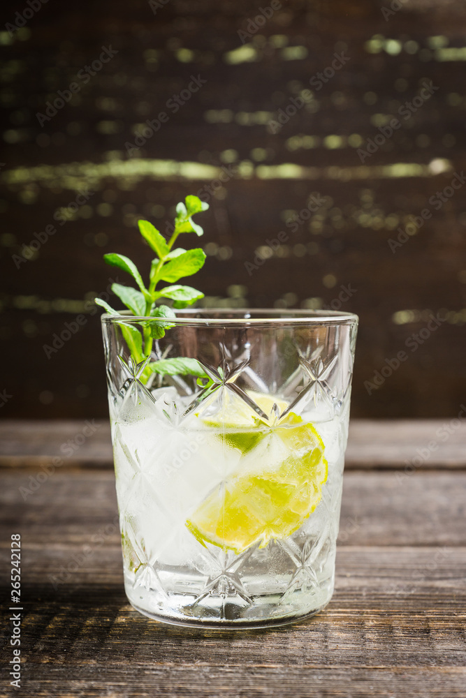Old fashioned beverage with lime and mint leaves. Selective focus. Shallow depth of field. Old fashioned beverage with lime and mint leaves. Selective focus. Shallow depth of field.