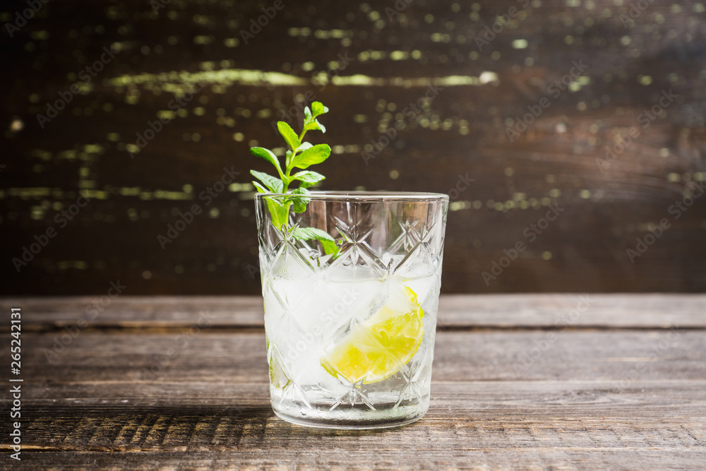 Old fashioned beverage with lime and mint leaves. Selective focus. Shallow depth of field. Old fashioned beverage with lime and mint leaves. Selective focus. Shallow depth of field.
