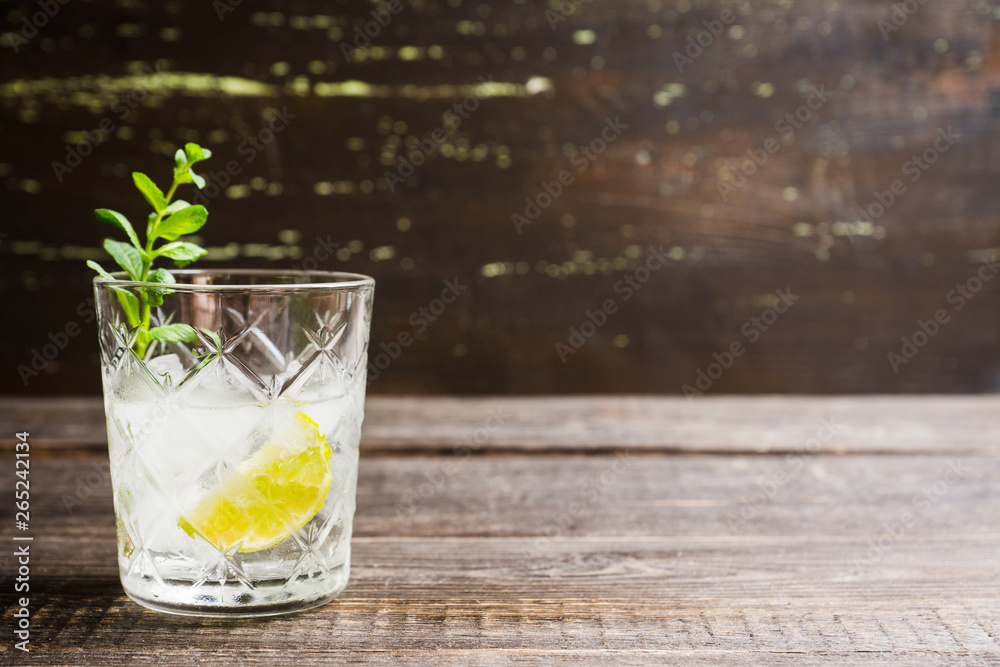 Old fashioned beverage with lime and mint leaves. Selective focus. Shallow depth of field. Old fashioned beverage with lime and mint leaves. Selective focus. Shallow depth of field.