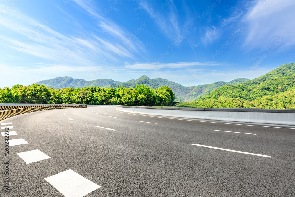 Country road and green mountains natural landscape under the blue sky