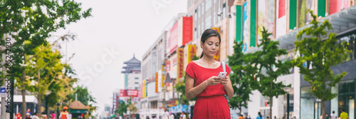 Photography Woman walking on Beijing street using mobile app