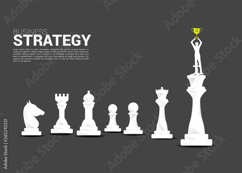 Silhouette of businessman standing on king chess piece. concept of winner in business and marketing strategy