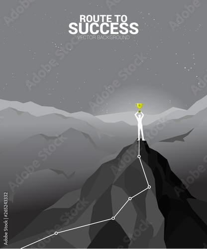 Silhouette of businessman with trophy on top of mountain. business concept of leadership and championship.route to success