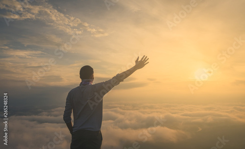 Asian men Travel Holiday Relaxation Concept , Vintage Style,sunrise clouds on top of mountain with misty.enjoying beautiful cloudscape.open arm