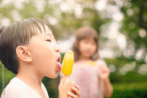 happy children eating popsicle at summertime