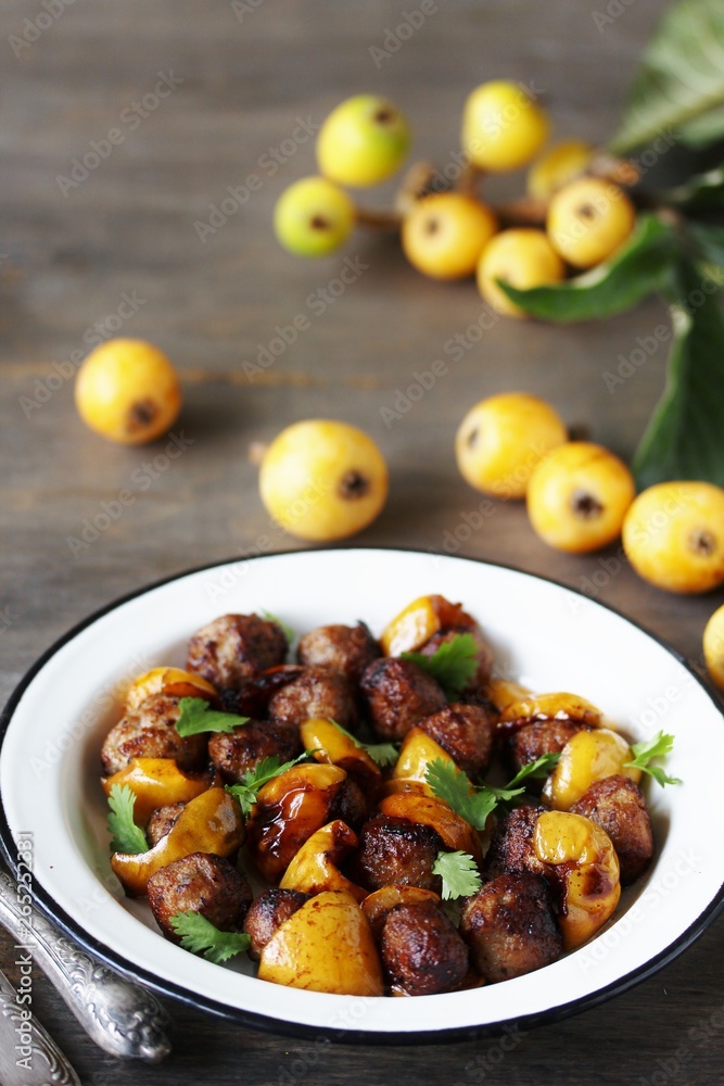 with a loquat dish. Meatballs with a loquat. or mini kebabs. medlar fruit with meatballs. Soft focus. Place for text. Copy Space with a loquat dish. Meatballs with a loquat. or mini kebabs. medlar fruit with meatballs. Soft focus. Place for text. Copy Space