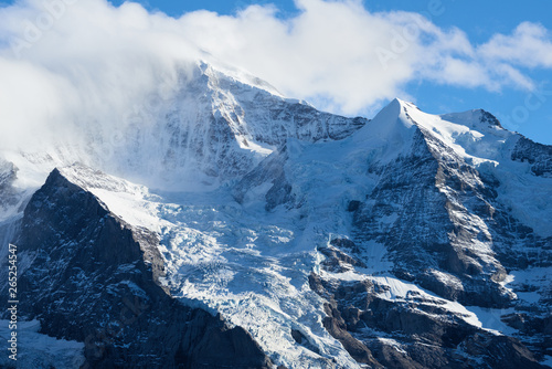 Mountain panorama with Jungfrau peak in the clouds in Lauterbrunnen in Switzerland. © thecolorpixels