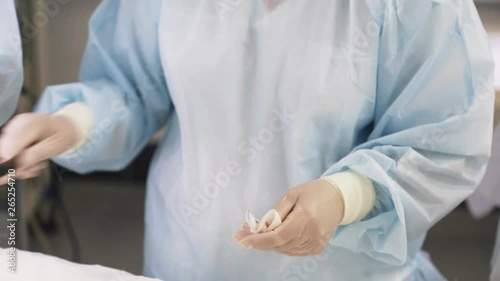 Wallpaper Mural Close up hands of nurse in gloves disinfects, wipes blood from medical instruments during surgery Torontodigital.ca