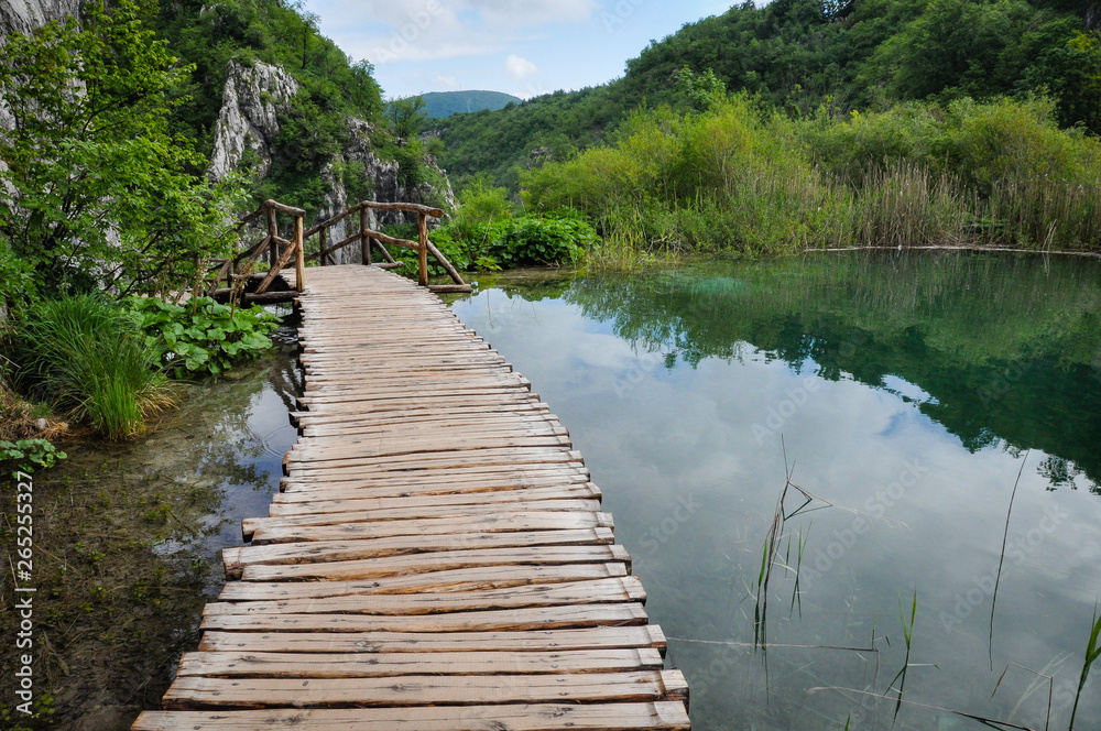 Wooden Hiking Trails in Plitvice Lakes National Park take you through lush green forest and over pristine lakes and waterfalls