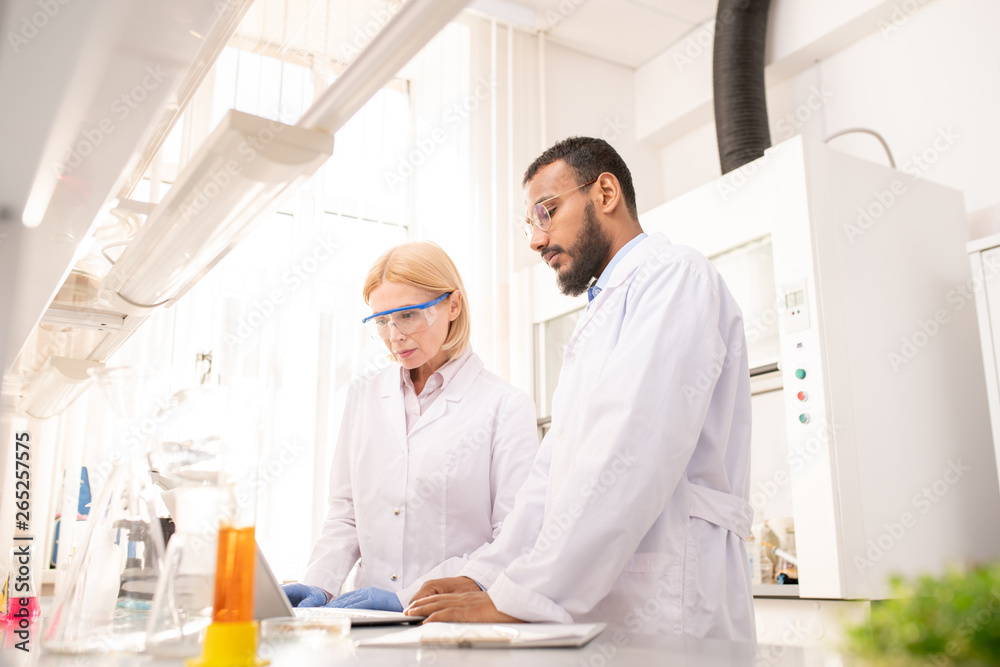 Laboratory researchers holding experiment Laboratory researchers holding experiment