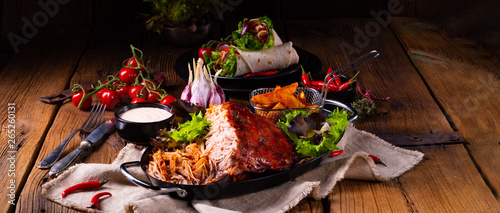 delicious pulled pork with baked potato quarters photo