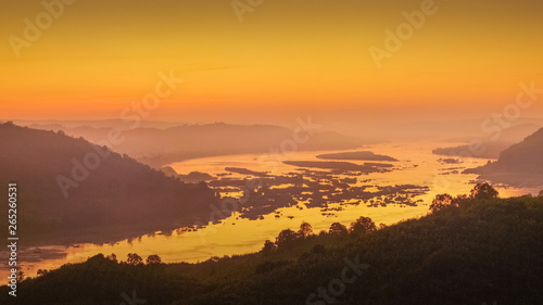 sunrise at Phu Huay Esan View Point  view of the hill around with sea of mist above Mekong river with red sun light in the sky background  Ban Muang  Sang Khom District  Nong Khai  Thailand.