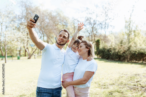 Family with children takes a selfie photo.