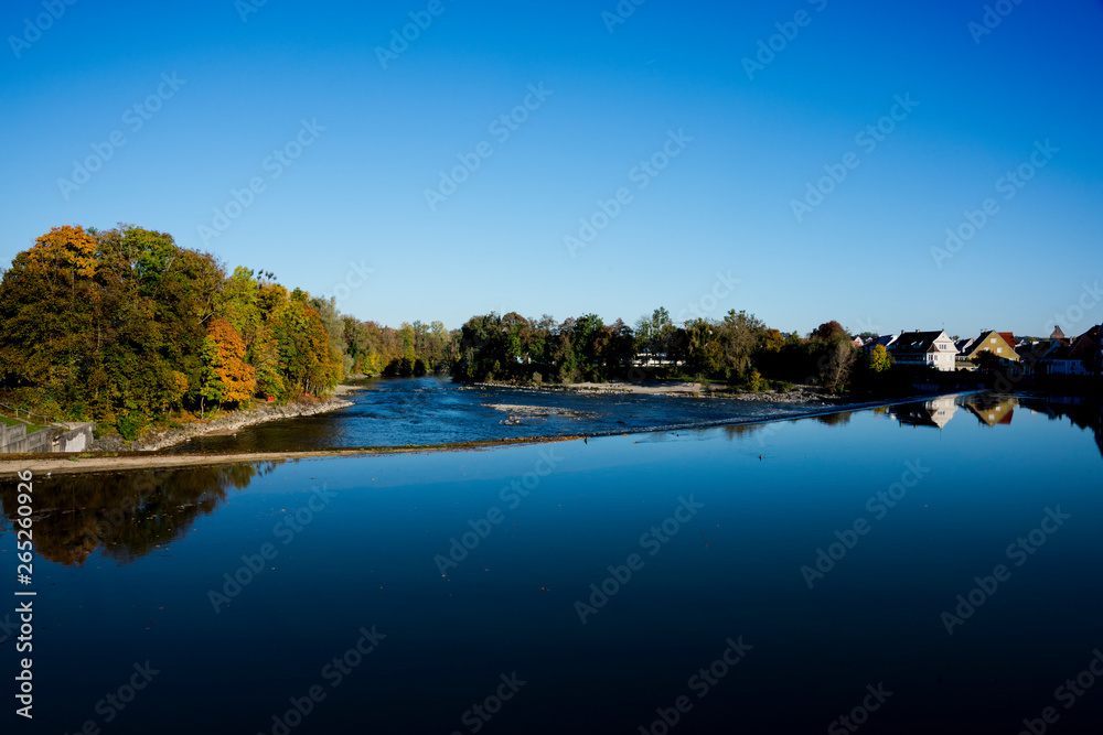 trees in autumn colors along river Lech, in Landsberg am Lech, Germany