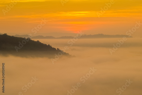 sunrise at Phu Huay Esan View Point, view of the hill around with sea of mist above Mekong river with red sun light in the sky background, Ban Muang, Sang Khom District, Nong Khai, Thailand.