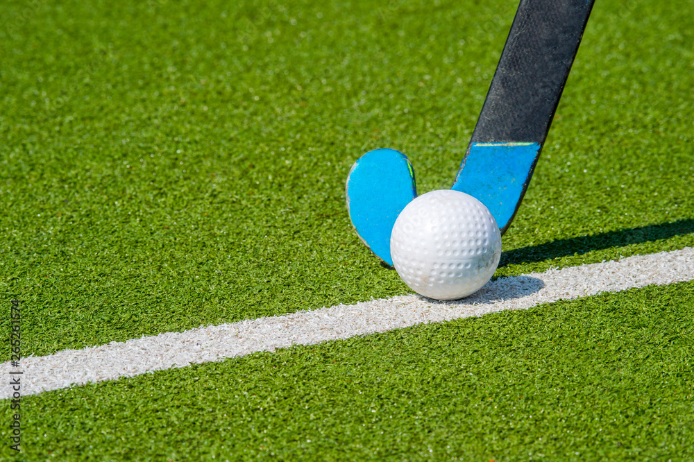 Field hockey stick and ball on green grass Stock Photo Adobe Stock