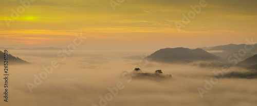 sunrise at Phu Huay Isan View Point, view of the hill around with sea of mist above Mekong river with yellow sun light in the sky background, Ban Muang, Sang Khom District, Nong Khai, Thailand.