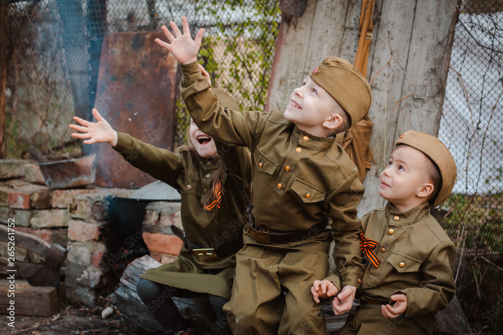 young child in military uniform on holiday day of victory, May 9, Russia.